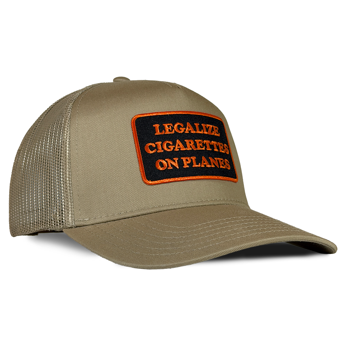A khaki trucker hat with a rectangular patch on the front that reads 'LEGALIZE CIGARETTES ON PLANES' in orange text on a black background, set against a plain white background. Hat by Crying in the Club Shirts