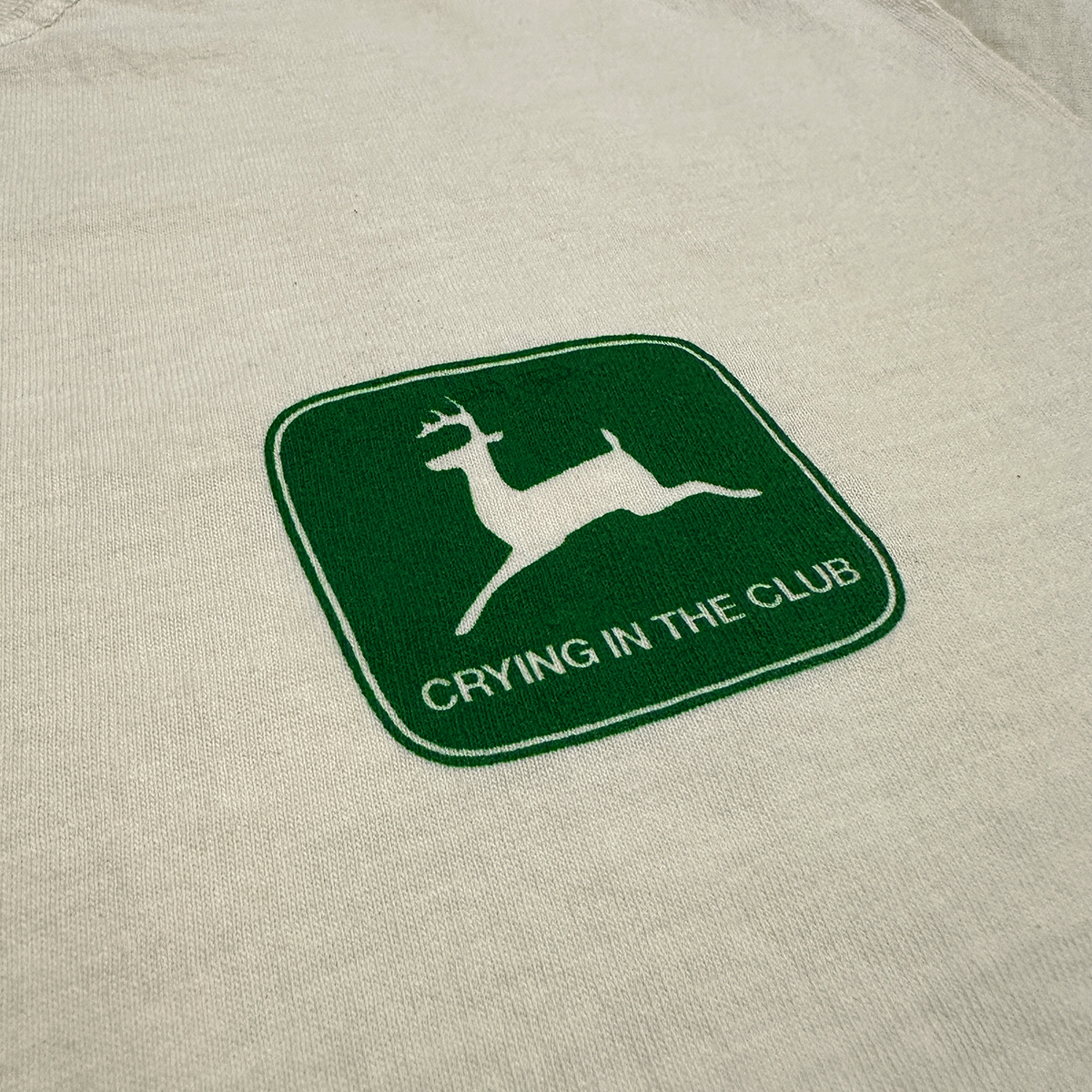 Green logo with a deer silhouette and 'Crying in the Club' text on a beige background - crying in the club You cant get a DUI on a lawnmower design