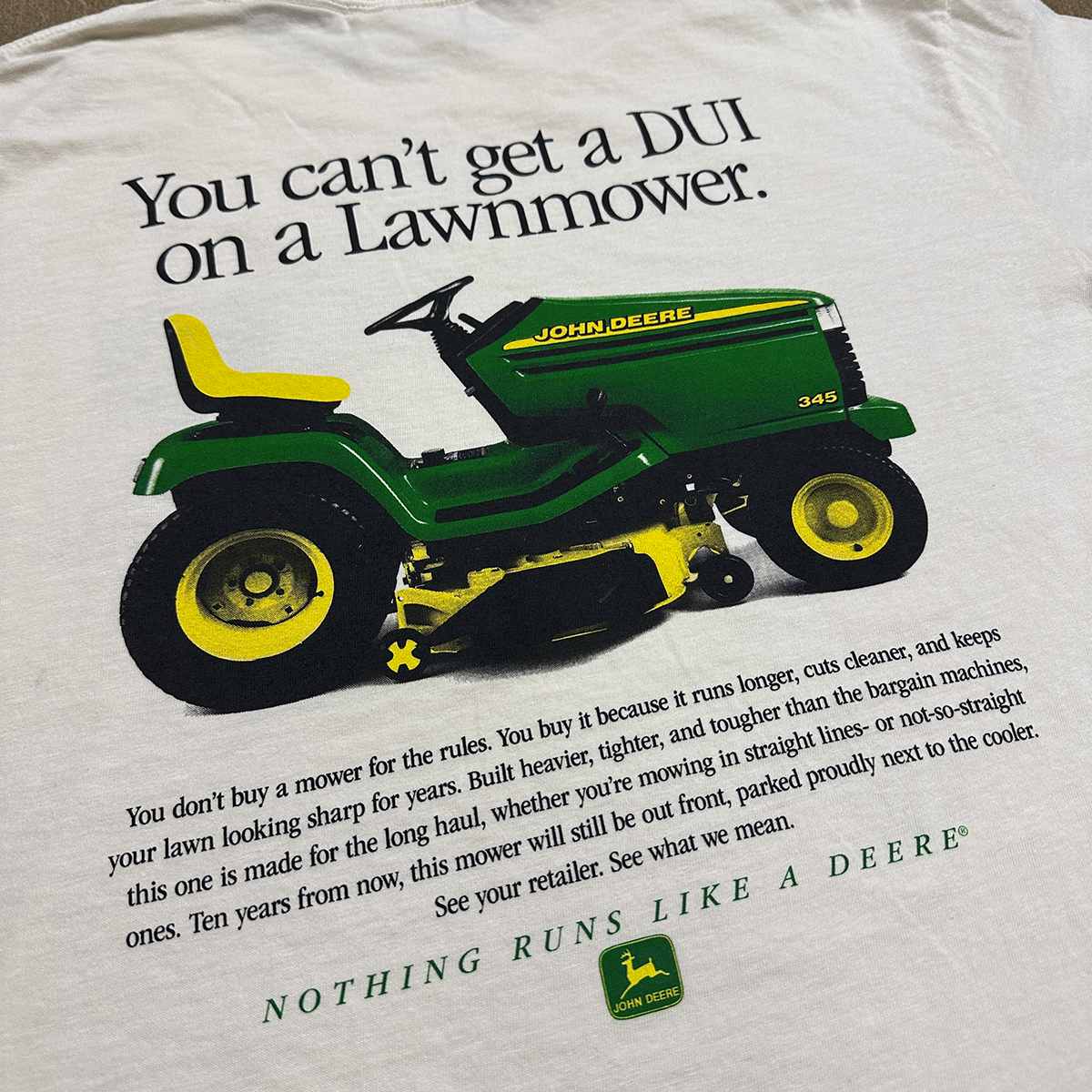 T-shirt with John Deere style lawn mower graphic and text on a white background, crying in the club You cant get a DUI on a lawnmower shirt