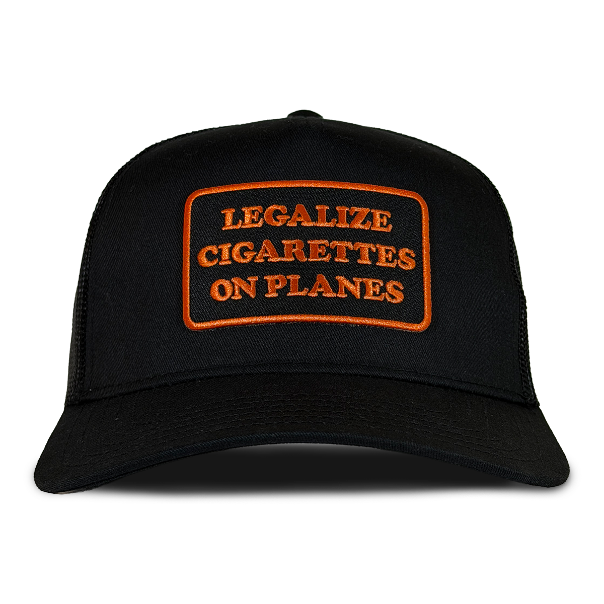 A black trucker-style cap with an orange embroidered patch on the front that reads 'LEGALIZE CIGARETTES ON PLANES'. Hat by Crying in the Club Shirts