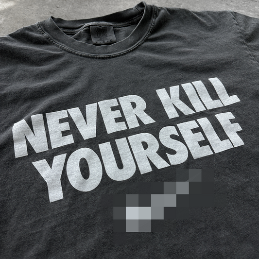 Black t-shirt with 'NEVER KILL YOURSELF' text in white on a gray surface