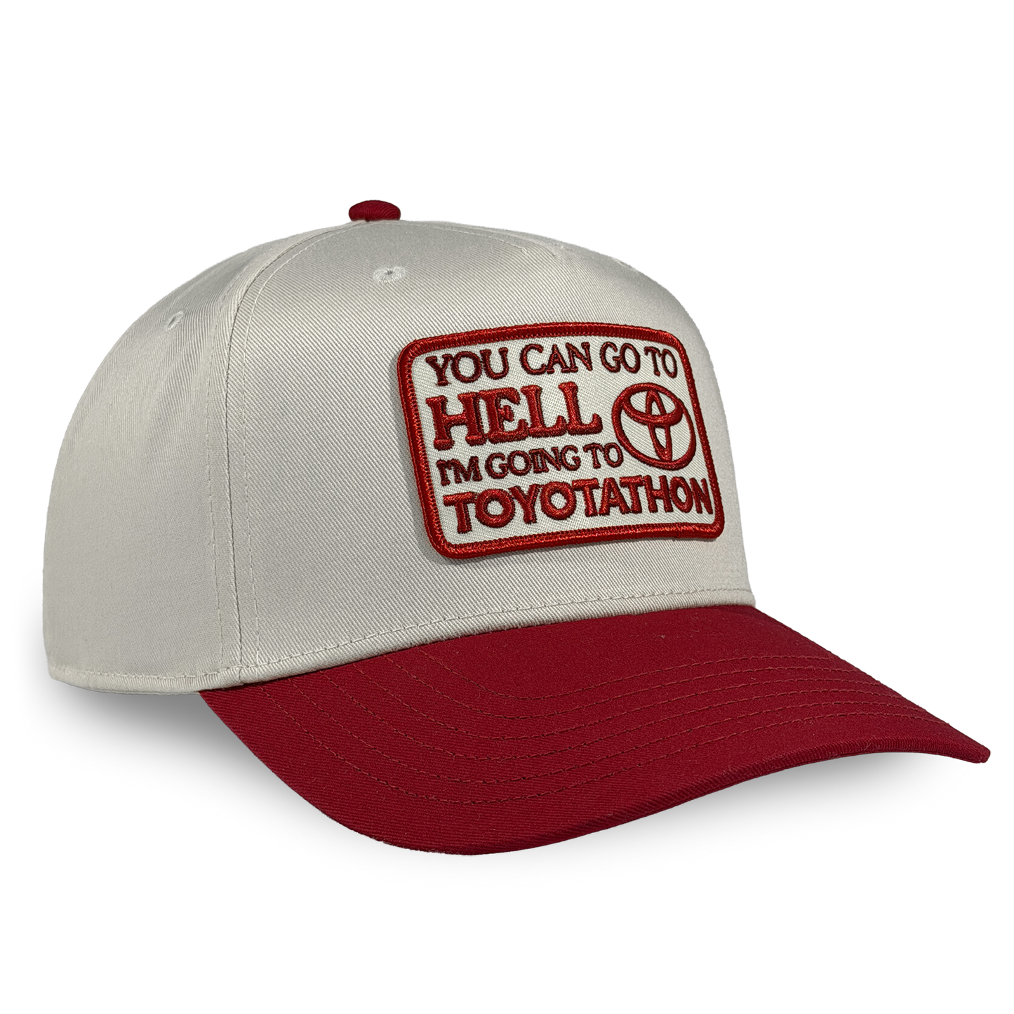 Cap with red and white text and logo on a beige and red background You can go to hell i'm going to toyotathon crying in the club shirts hat