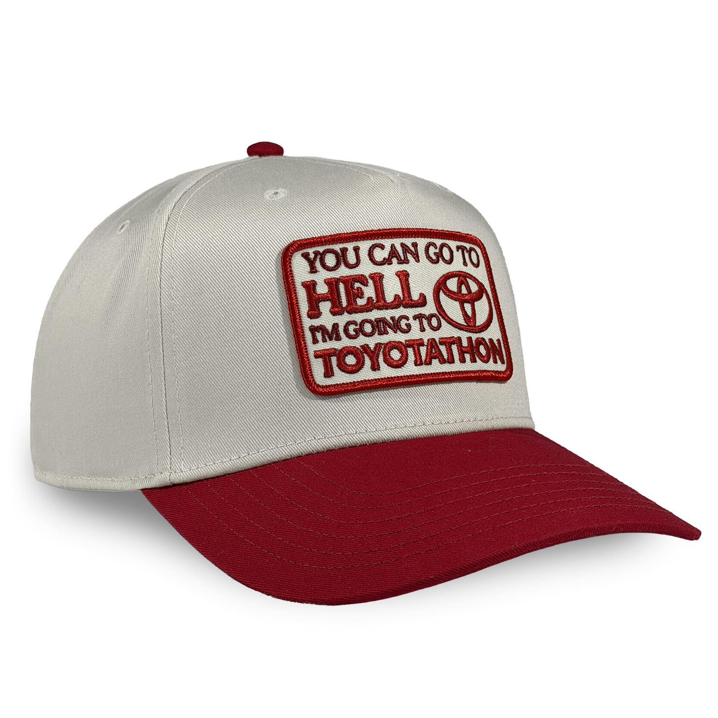 Cap with red and white text and logo on a beige and red background You can go to hell i'm going to toyotathon crying in the club shirts hat