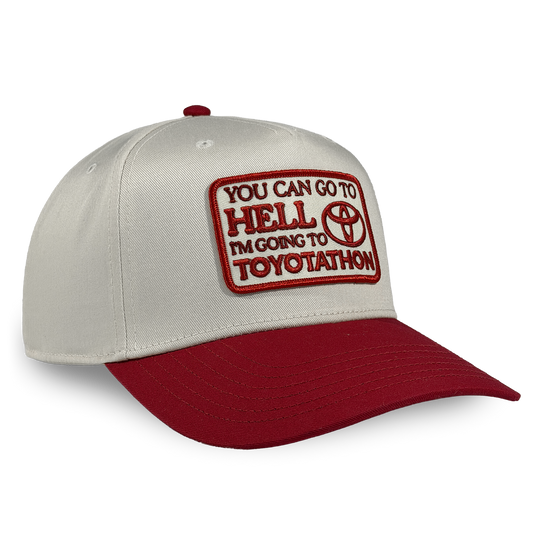 Cap with red and white text and logo on a beige and red background You can go to hell i'm going to toyotathon crying in the club shirts hat