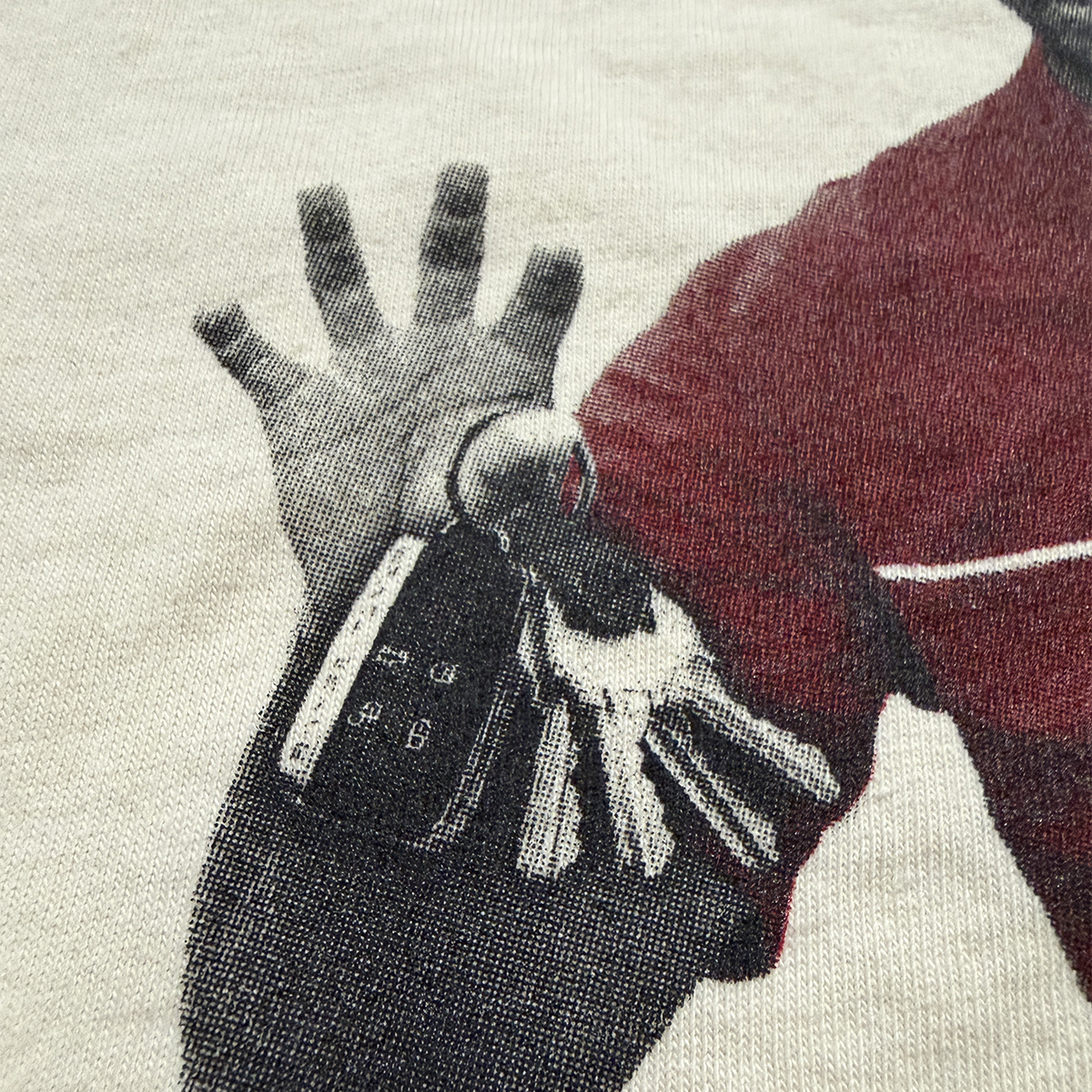 Illustration of tiger's hand holding a key with with the keyfob from the dui crashed range rover, on a textured fabric background. 