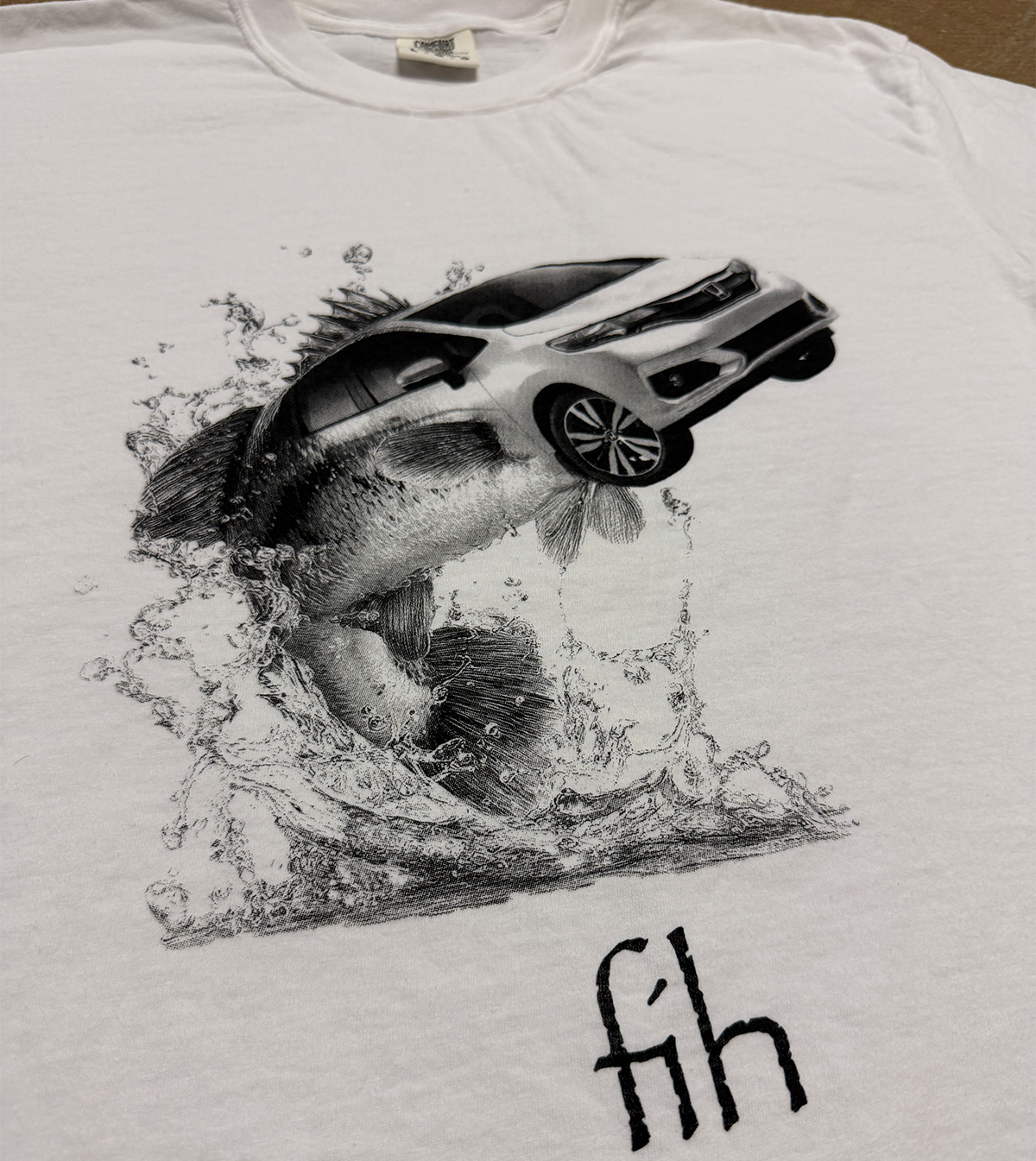 White t-shirt with a graphic of a fish carrying a car underwater, with 'fih' text. white tshirt with a screen print of what appears to be a honda fit car combined with a fish labeled "fih"